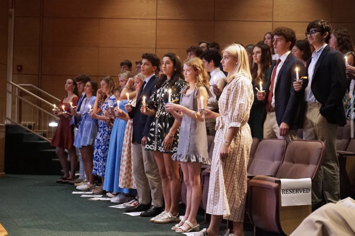 Inductees light candles that symbolize their membership
